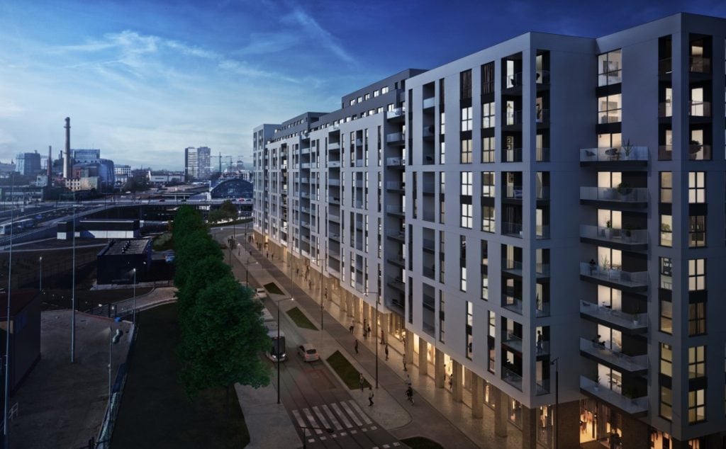 Co czeka rynek nieruchomości w 2023 roku? - blok mieszkalny na tle miasta. 