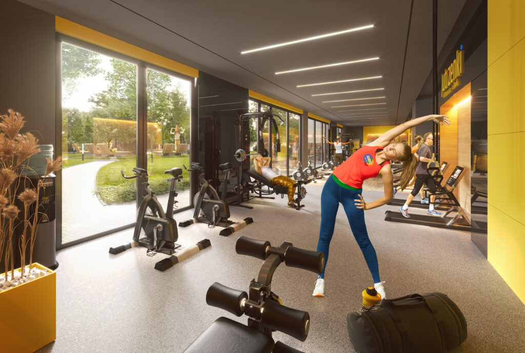 Mieszkanie na wagę złota – komentarz Shragi Weisman, CEO Aurec Home - kobieta ćwiczy na siłowni 