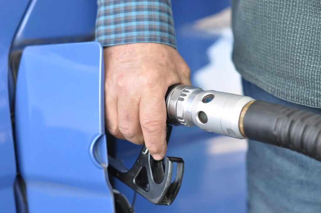Z czego wynikają tak wysokie ceny paliw? - mężczyzna tankuje auto. 