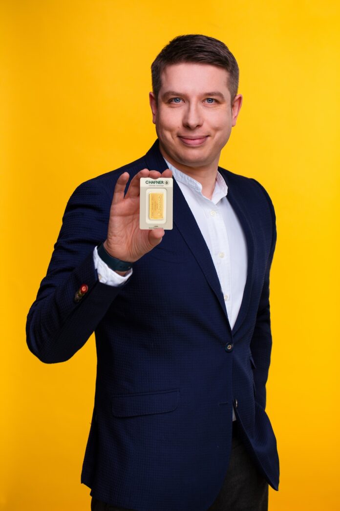 Michał Tekliński trzymający sztabkę złota